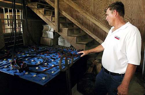 Beall shows off wind turbine batteries.